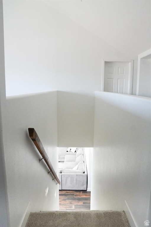 Stairway featuring baseboards and wood finished floors
