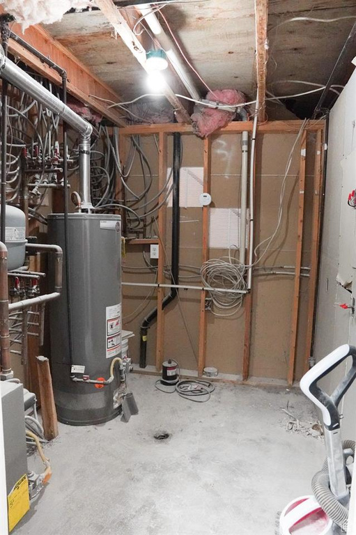 Utility room featuring gas water heater