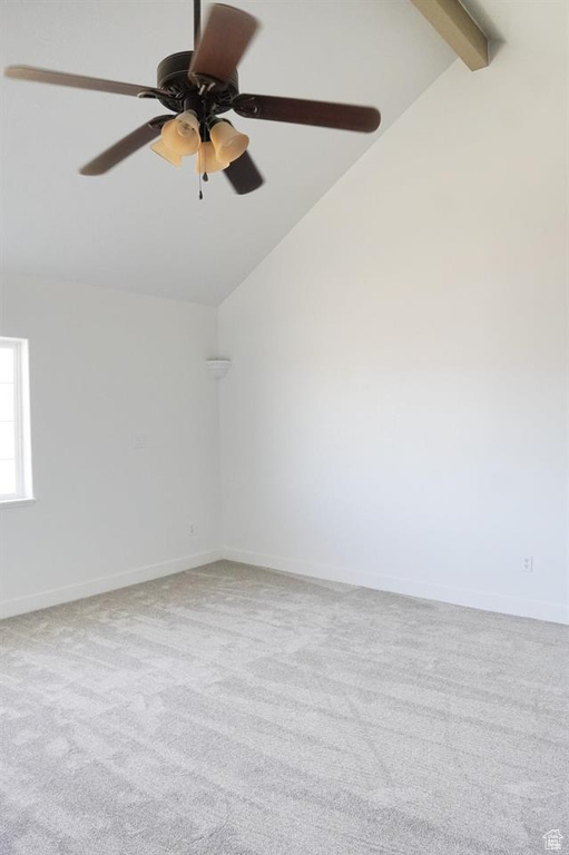 Carpeted spare room featuring ceiling fan and baseboards