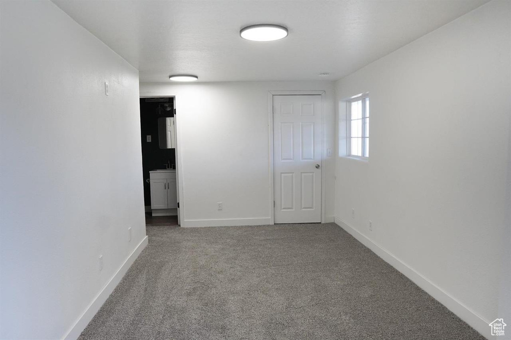 Spare room featuring carpet floors and baseboards