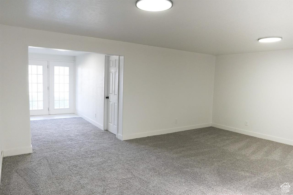 Unfurnished room featuring carpet and baseboards