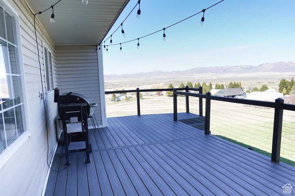 Wooden terrace featuring a mountain view and grilling area