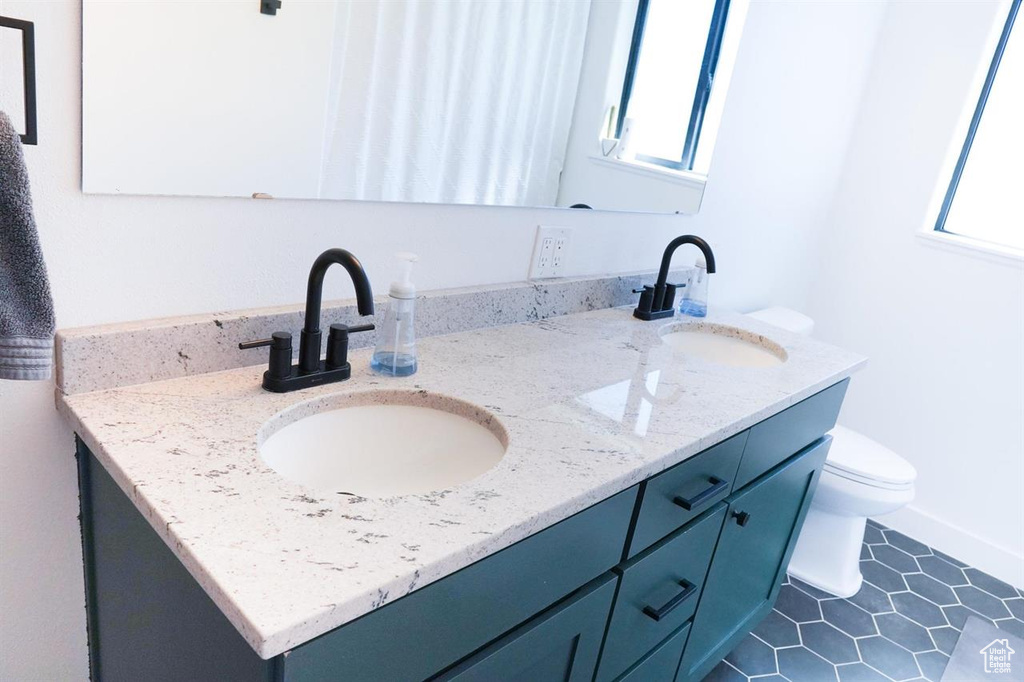 Bathroom with double vanity and toilet