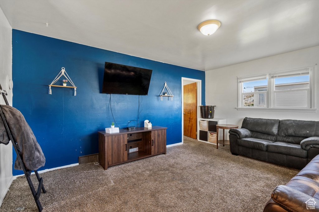 Carpeted living room featuring baseboards