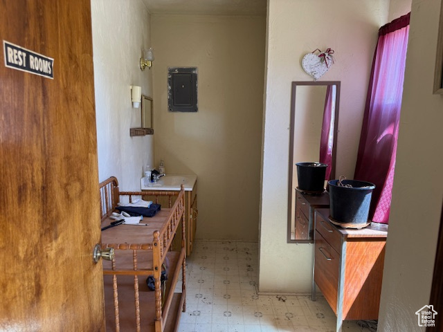 Bathroom featuring electric panel and tile patterned floors