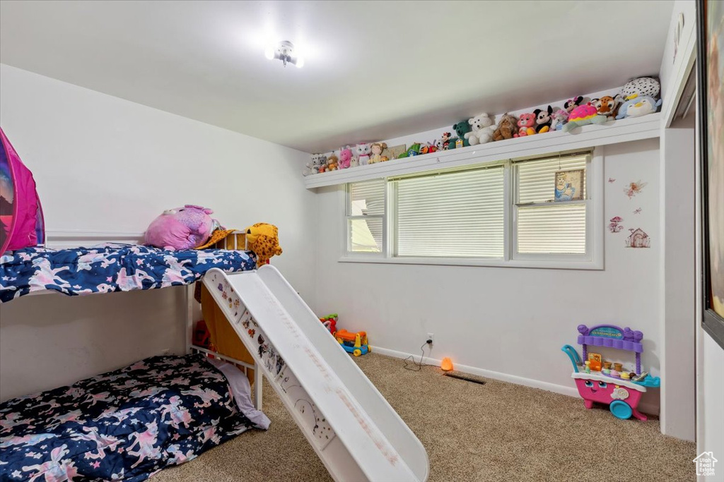 Bedroom with carpet flooring and baseboards
