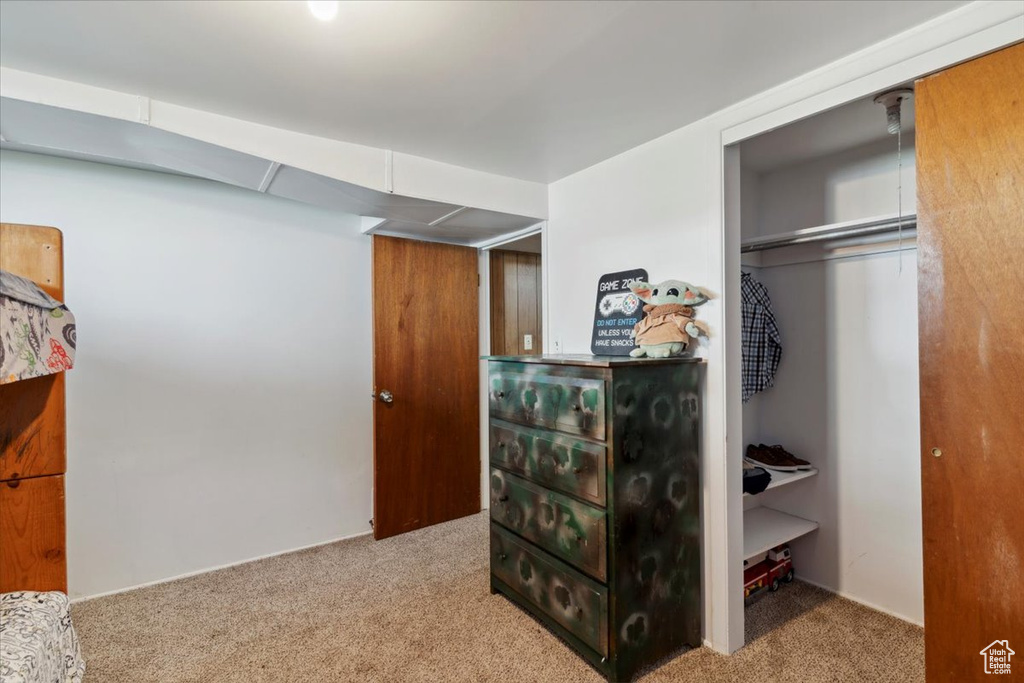 Carpeted bedroom featuring a closet