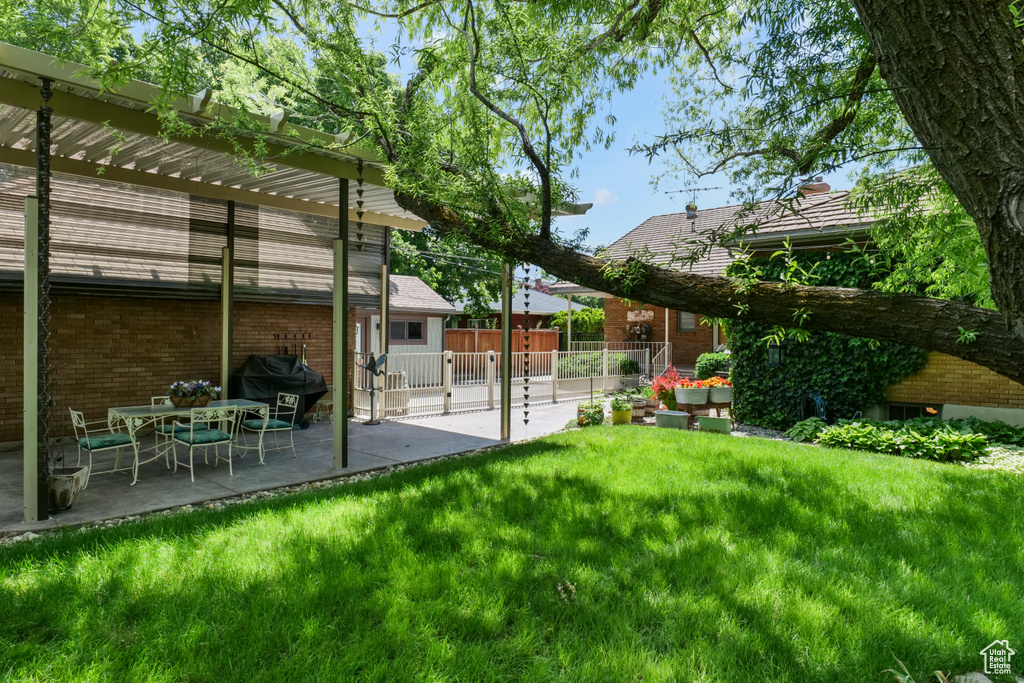 View of yard featuring a pergola and a patio area