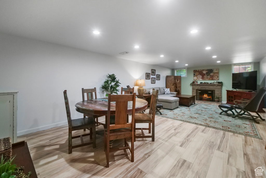 Dining area featuring a fireplace, recessed lighting, and light wood finished floors
