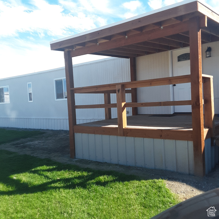 Wooden deck featuring a lawn