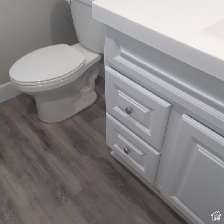 Bathroom with toilet and wood finished floors
