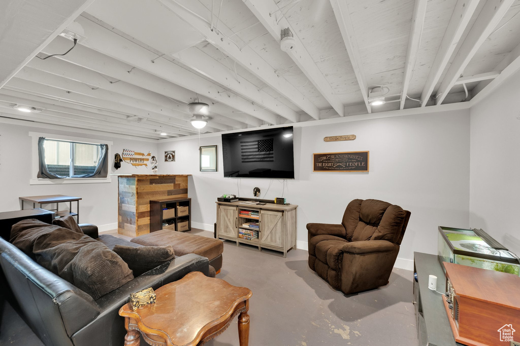 Living area featuring finished concrete floors and baseboards