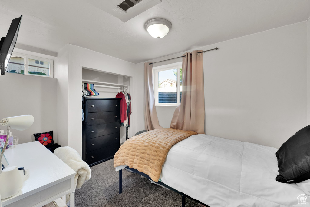 Carpeted bedroom with a closet