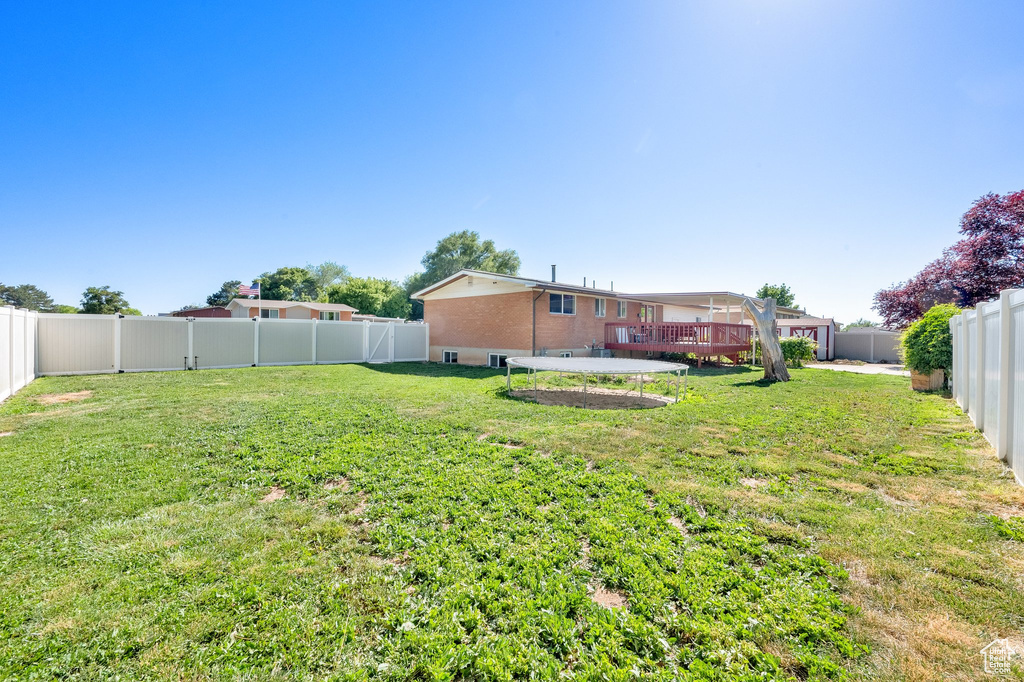 View of yard with a wooden deck