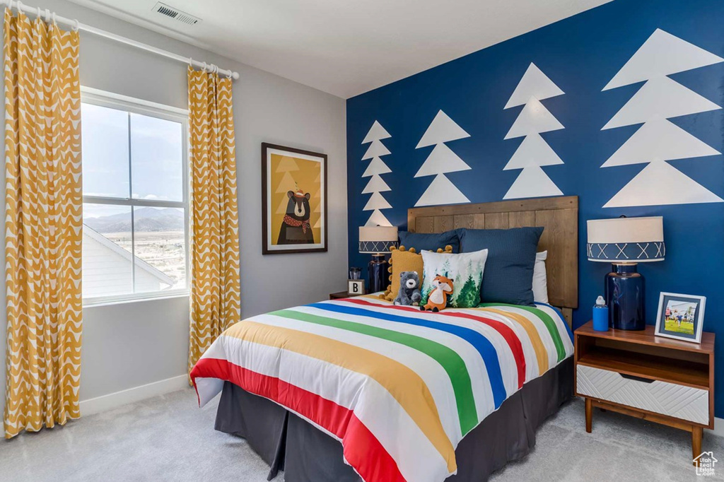 Bedroom featuring carpet and baseboards