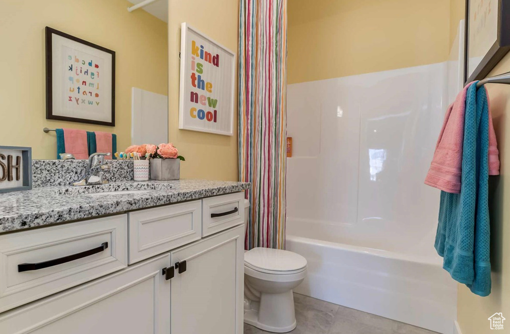 Bathroom with vanity, toilet, and shower / bath combo with shower curtain