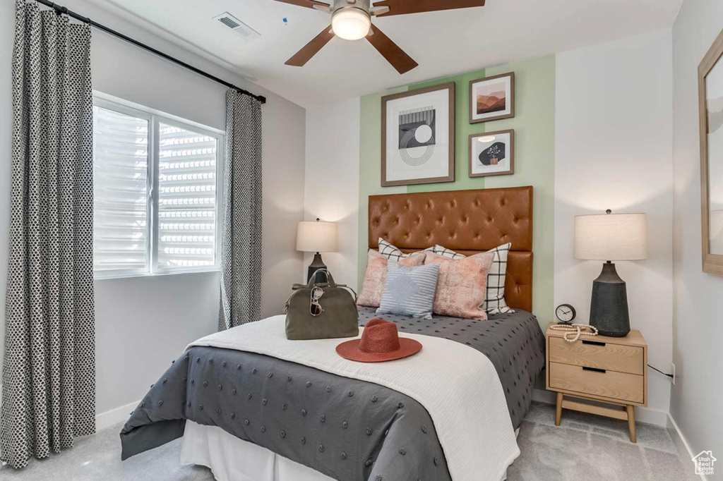 Bedroom with baseboards, carpet flooring, and a ceiling fan