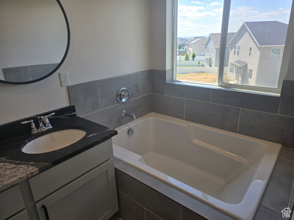 Bathroom with vanity and a bath