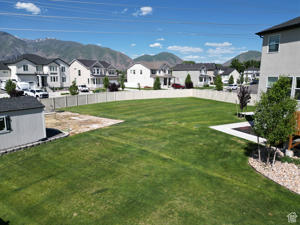 View of yard with a residential view and a mountain view