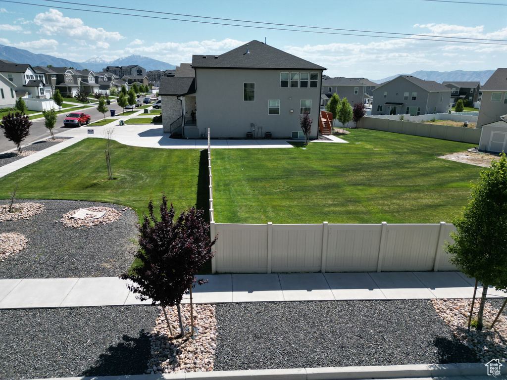 Back of property featuring a residential view, stucco siding, and a mountain view