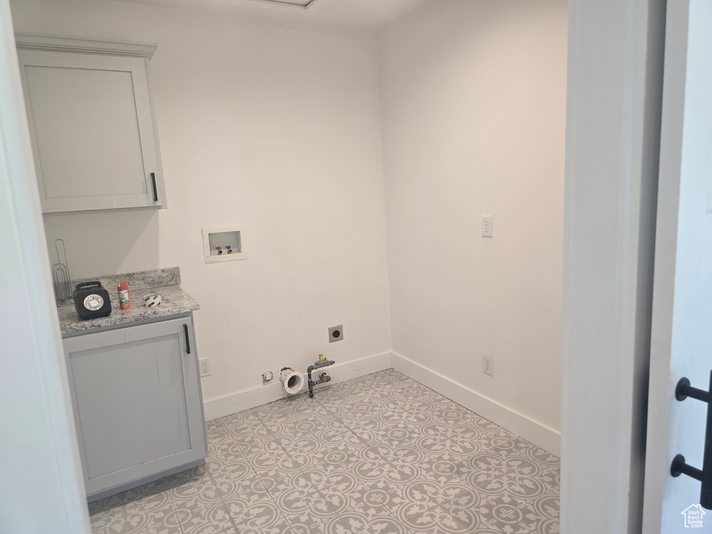 Laundry room featuring washer hookup, gas dryer hookup, baseboards, hookup for an electric dryer, and cabinet space