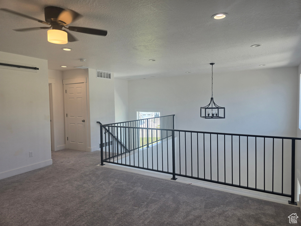 Empty room featuring carpet flooring, baseboards, recessed lighting, a ceiling fan, and a textured ceiling