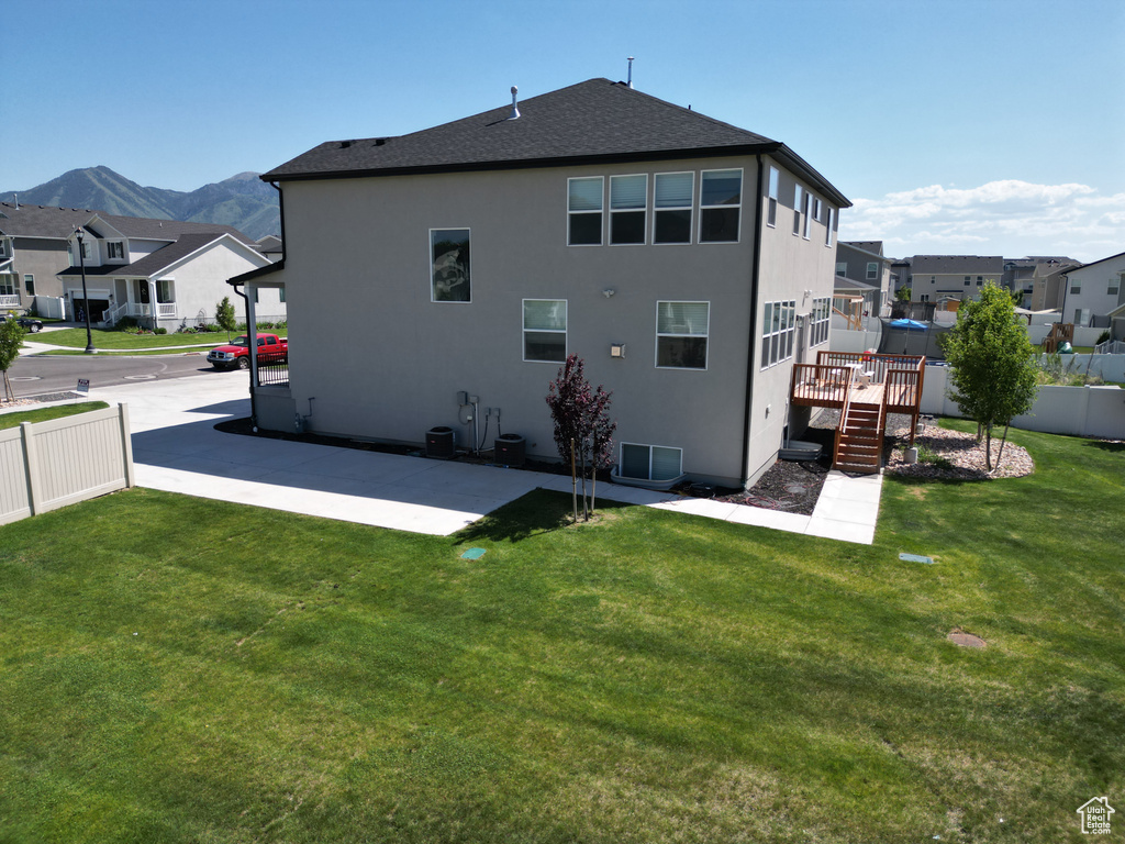 Rear view of house with a residential view, a patio, a deck with mountain view, and stucco siding