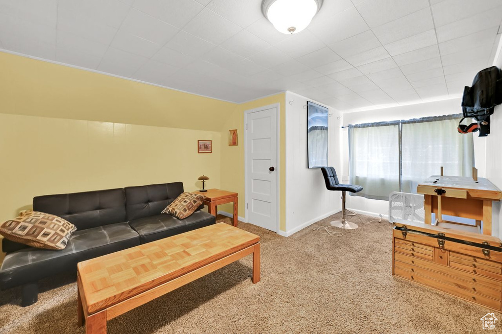 Living area featuring carpet flooring and baseboards