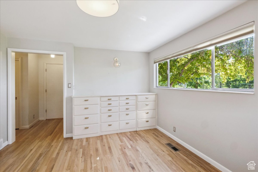 Unfurnished bedroom with light wood-style flooring and baseboards