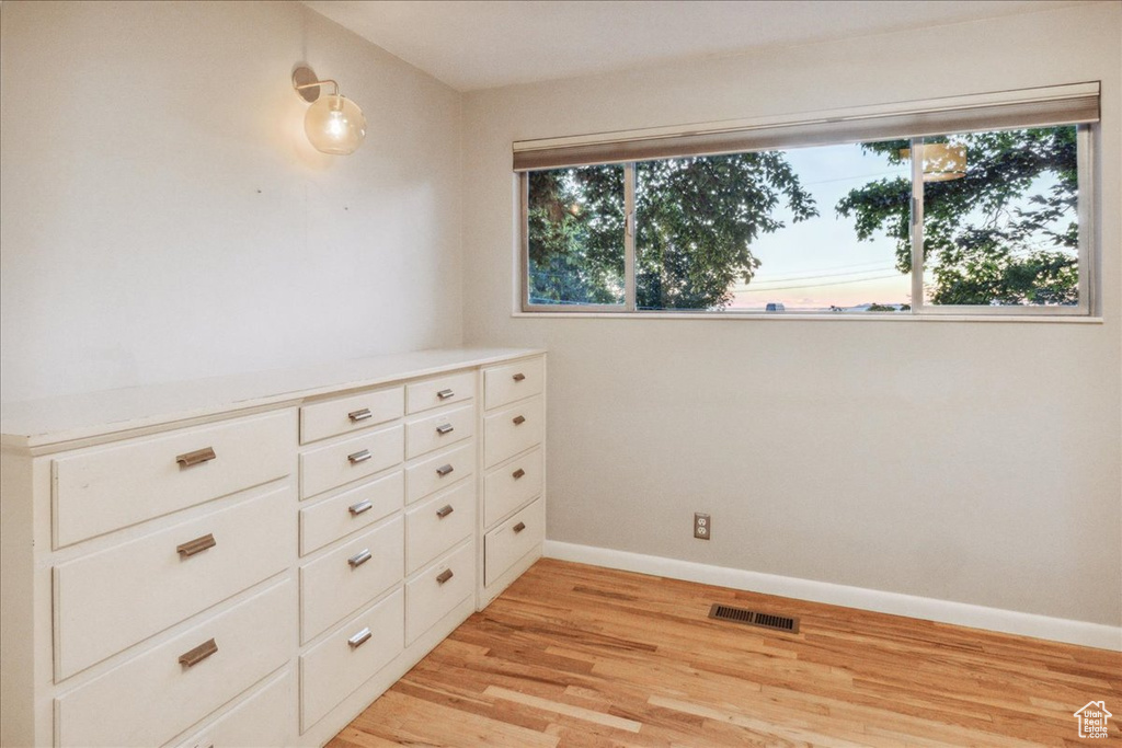 Unfurnished room with light wood-style floors and baseboards