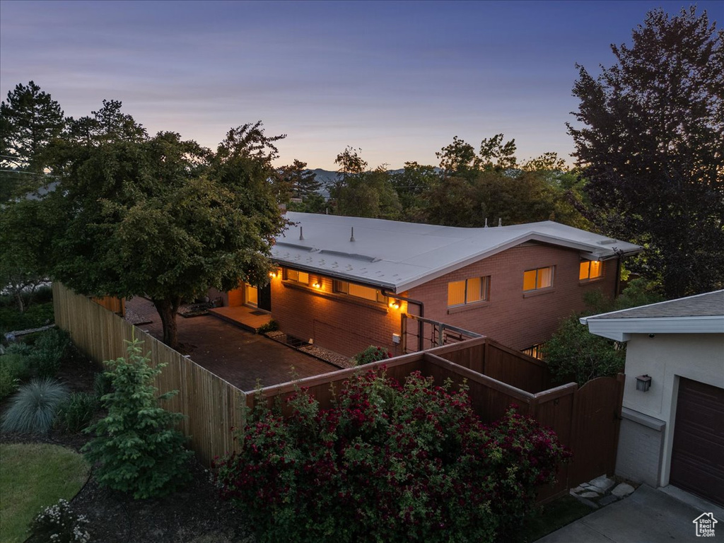 View of back of property at dusk