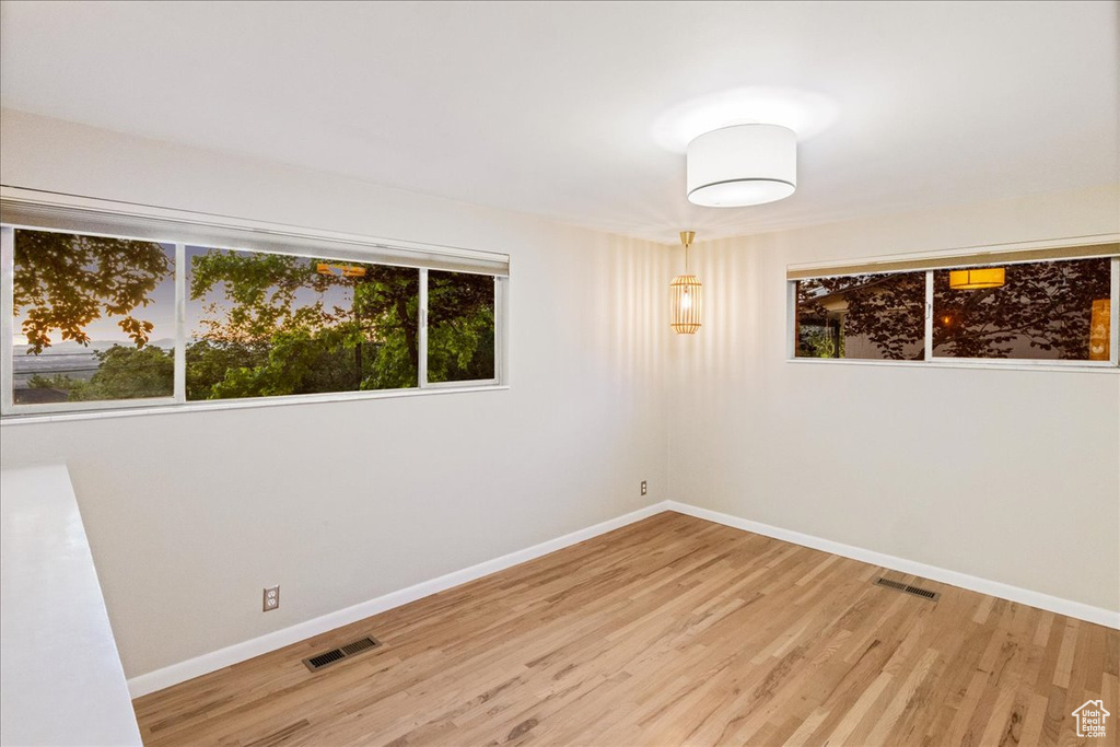 Empty room with wood finished floors and baseboards