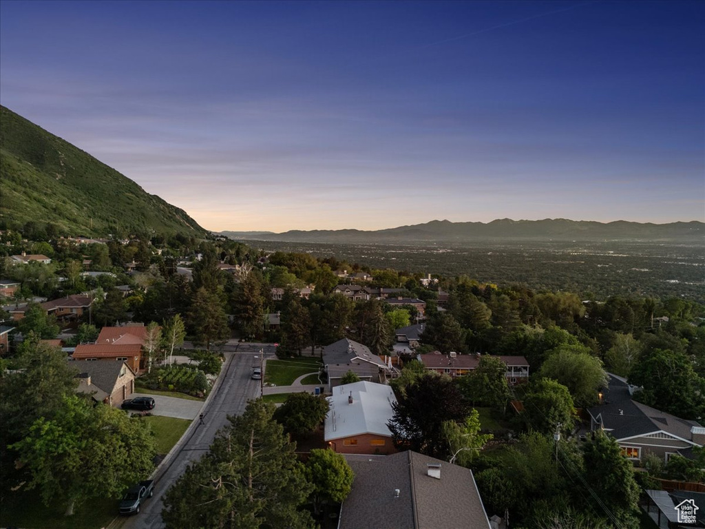 Aerial overview of property\'s location featuring a mountain backdrop and nearby suburban area