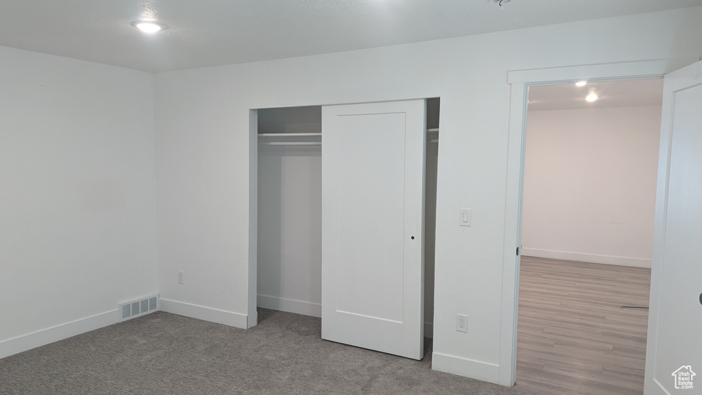 Unfurnished bedroom with a closet and baseboards