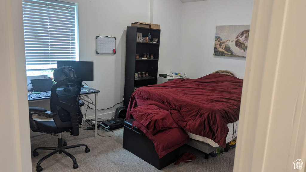 Bedroom featuring an office area and carpet