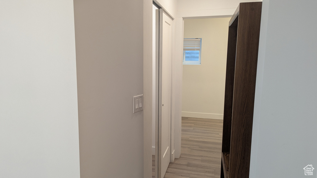 Hall with light wood finished floors and baseboards