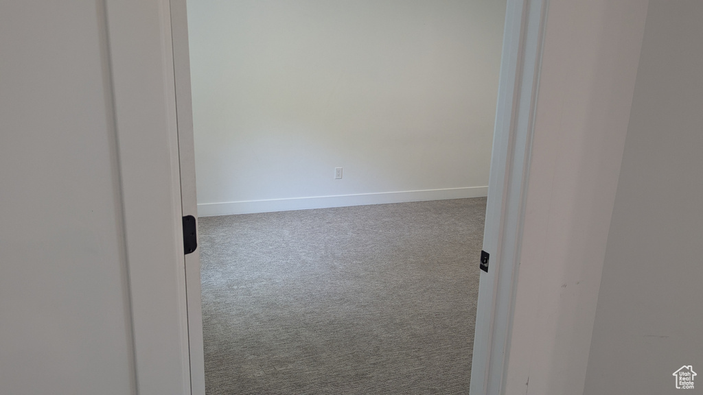Spare room with carpet and baseboards