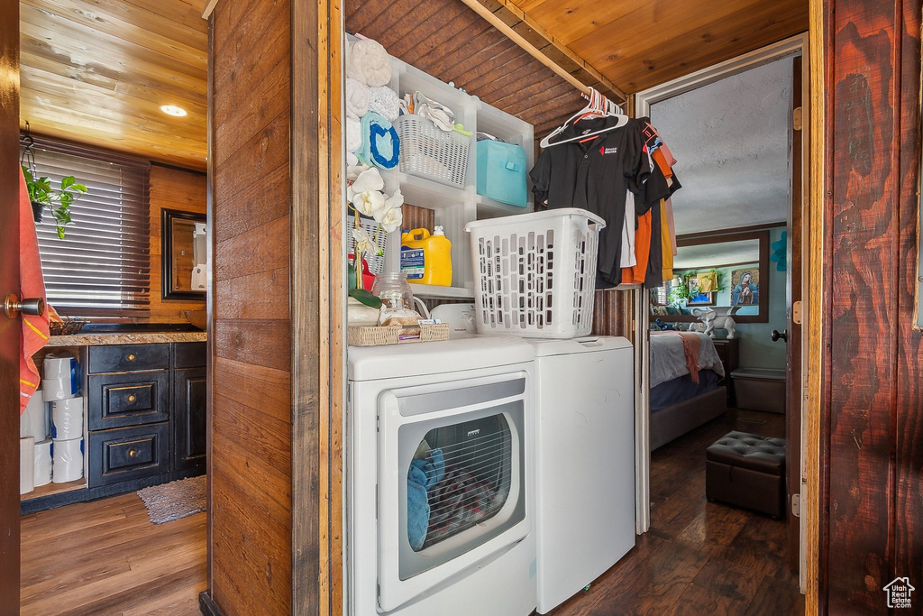 Laundry room featuring washer and dryer, wood ceiling, and wood finished floors