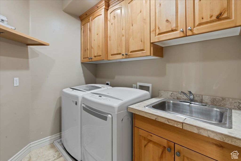 Laundry room with cabinet space, washing machine and clothes dryer, and baseboards