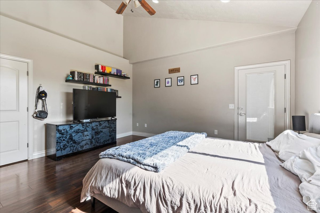 Bedroom featuring wood finished floors, baseboards, high vaulted ceiling, and a ceiling fan