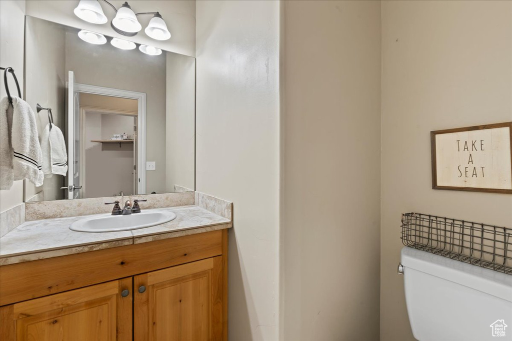 Half bathroom with vanity and toilet
