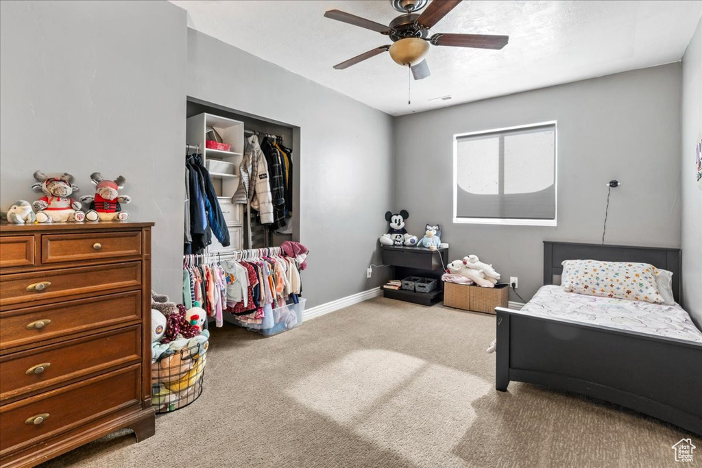Bedroom featuring carpet, baseboards, a closet, and a ceiling fan