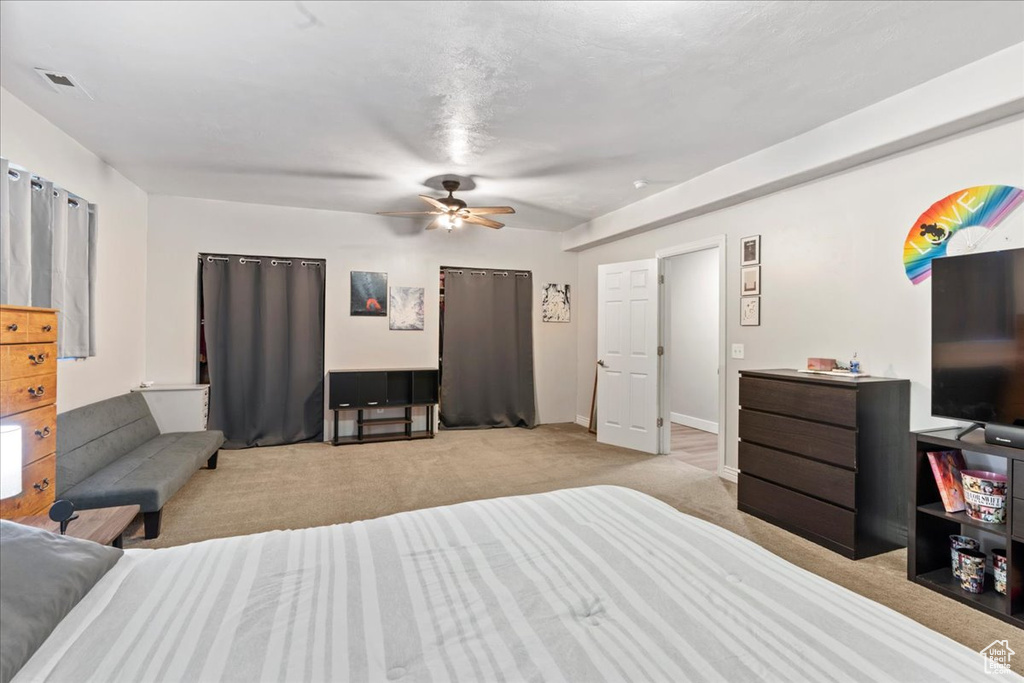 Bedroom with light carpet and ceiling fan