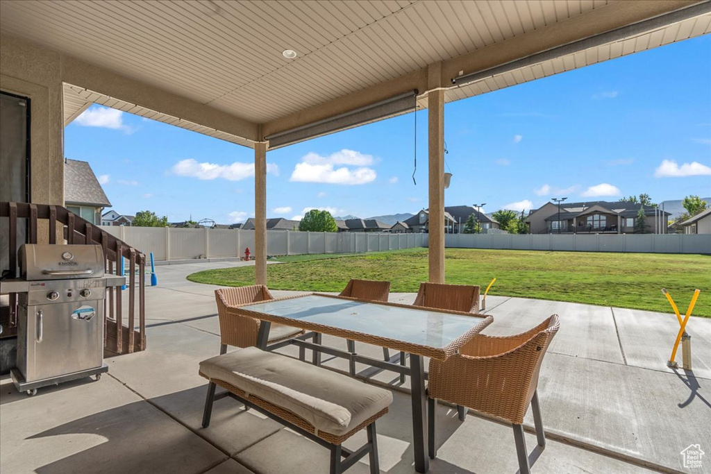 View of patio / terrace featuring outdoor dining area, area for grilling, and a residential view