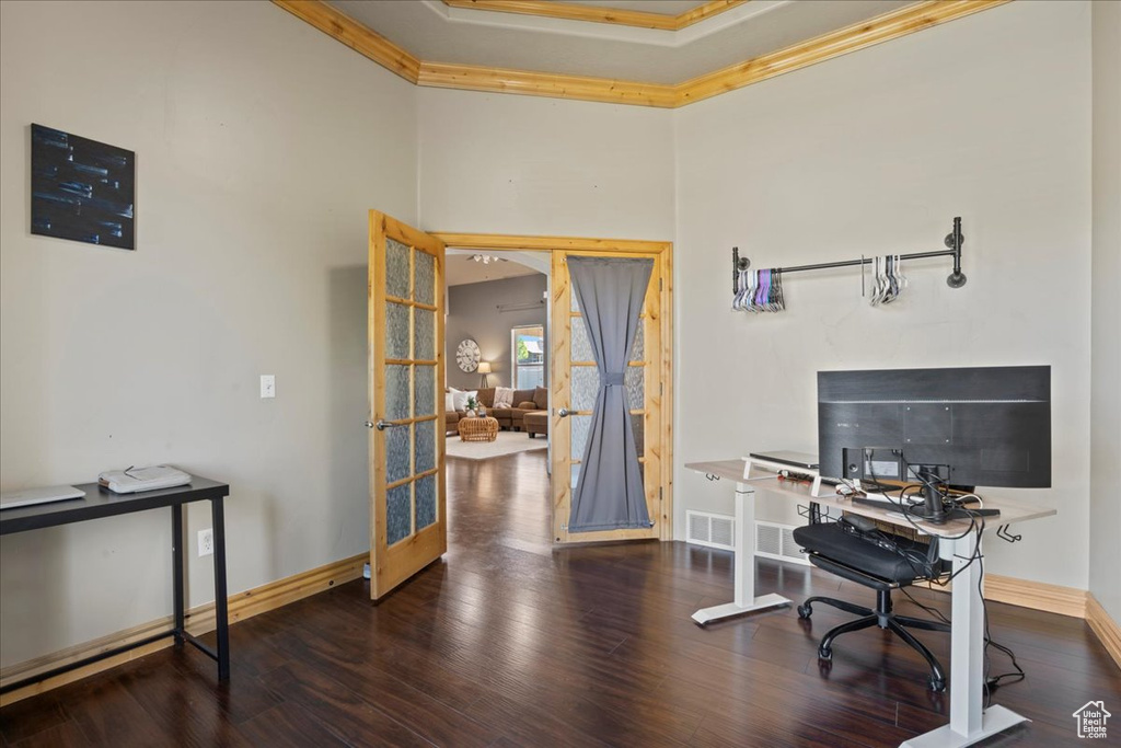 Home office featuring crown molding, baseboards, wood finished floors, and french doors