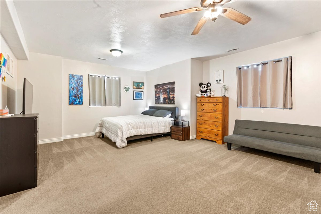 Bedroom with carpet, baseboards, and a ceiling fan
