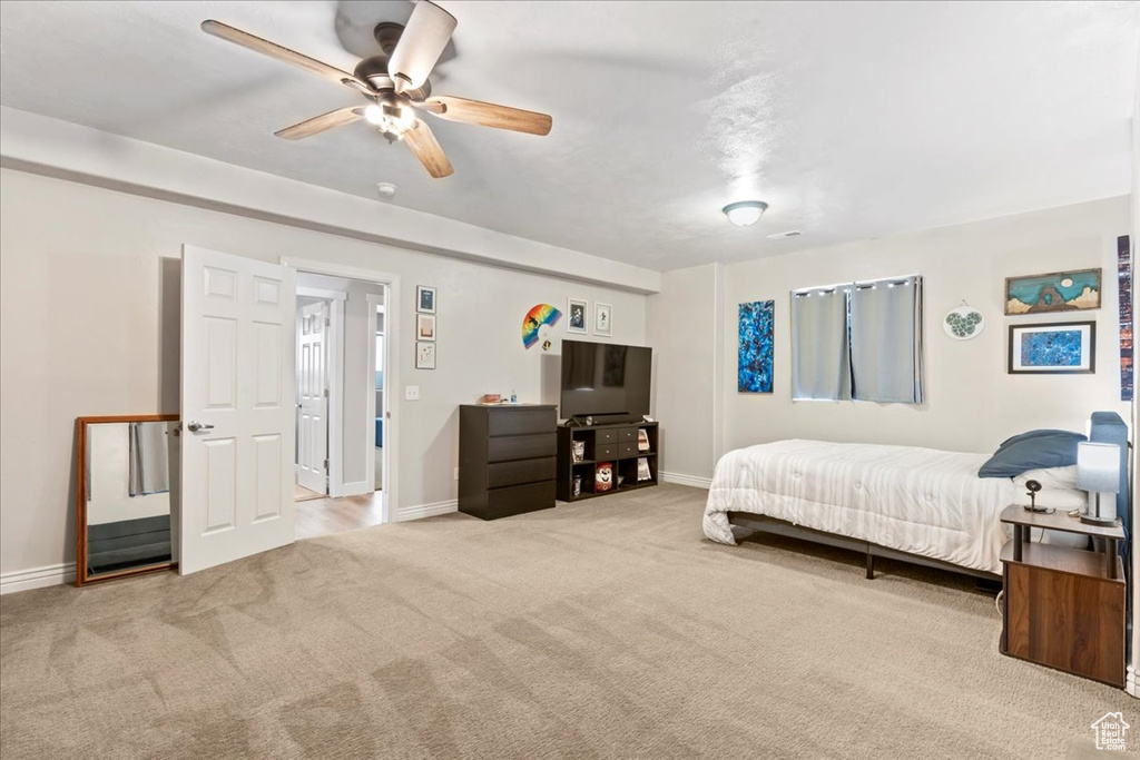 Bedroom with carpet floors, baseboards, and ceiling fan