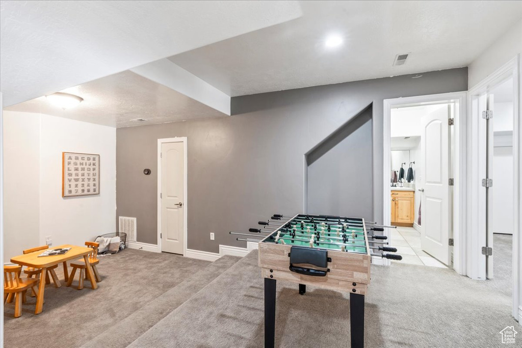 Game room featuring light colored carpet and baseboards