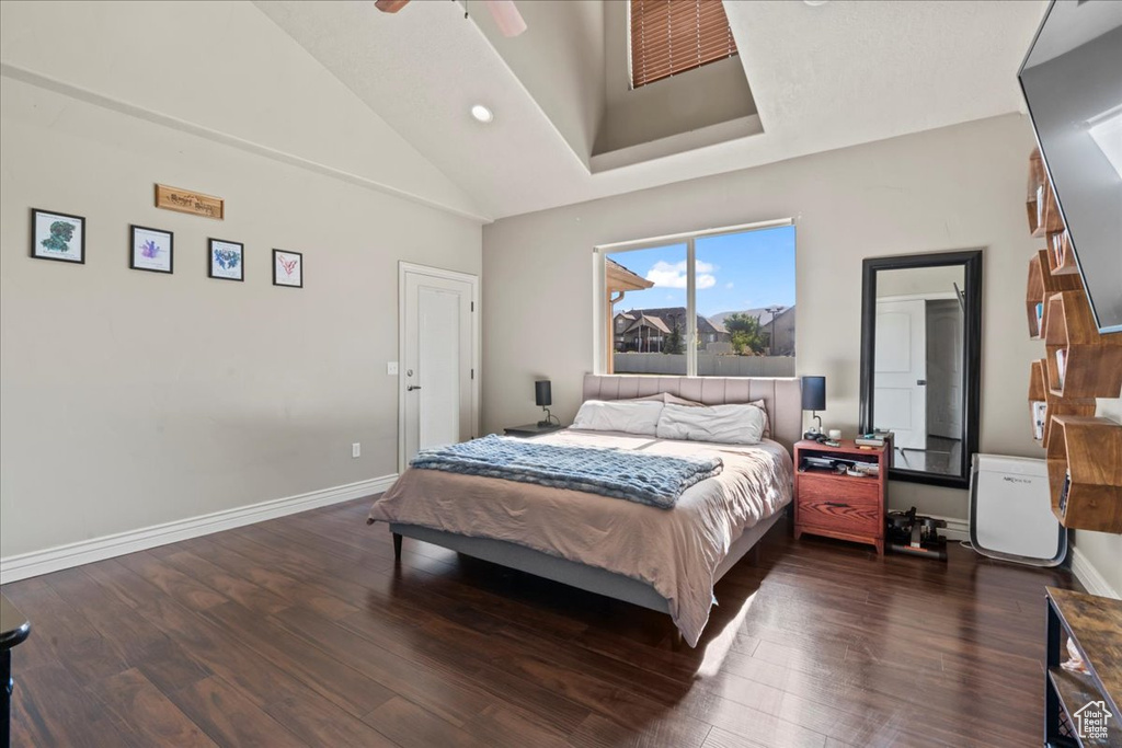 Bedroom with high vaulted ceiling, wood finished floors, recessed lighting, baseboards, and a ceiling fan
