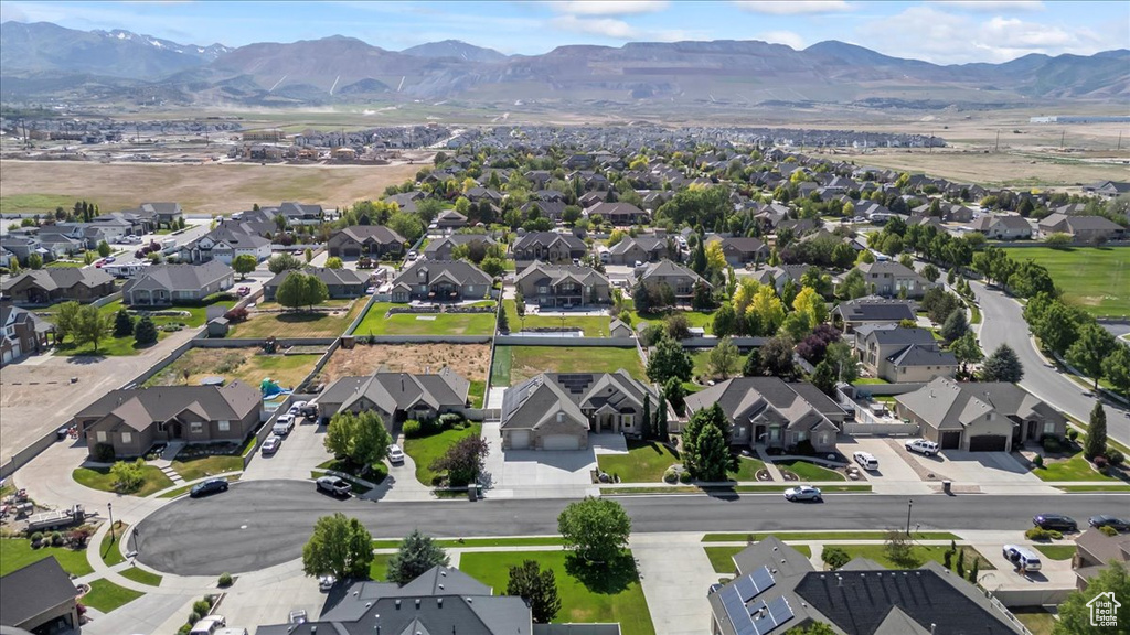 Aerial overview of property\'s location featuring nearby suburban area and a mountainous background